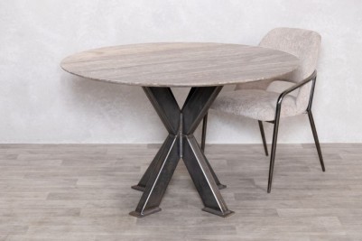 round-travertine-top-table-gunmetal-tank-trap-base